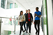 College students walking and talking in corridor