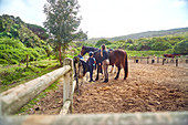 Instructor teaching horseback riding to girl