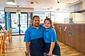 Portrait young women with Down Syndrome working in cafe