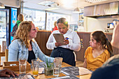 Young server with Down Syndrome taking customer order