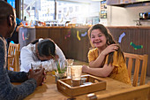 Happy woman with Down Syndrome in cafe