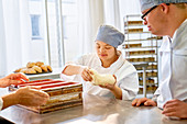 Young students with Down Syndrome baking bread in class