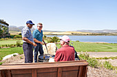 Male golfer friends talking drinking beer