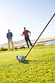 Golfer preparing to tee off on sunny golf course