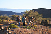 Safari tour guide explaining plants to group South Africa