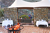 Senior friends relaxing with wine on hotel patio