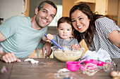 Portrait happy young family baking
