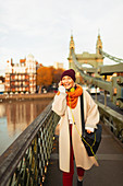 Woman talking on smart phone on urban bridge