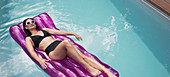 Woman relaxing, laying on inflatable raft