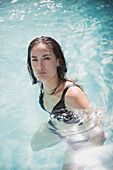 Woman swimming in summer swimming pool