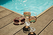 Rose wine glasses and sunglasses at poolside