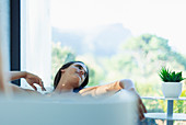 Serene woman relaxing in soaking tub