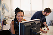 Portrait female engineer working at computer in office