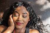 Serene woman listening to music with headphones