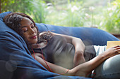 Woman with headphones listening to music in beanbag chair