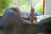 Portrait woman relaxing with tablet in beanbag chair