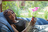 Portrait beautiful woman with smart phone in beanbag chair