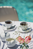 Roses and coffee on patio table