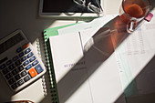 Retirement portfolio on table with tea and calculator