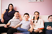 Happy family relaxing on living room sofa