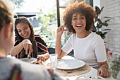 Women friends enjoying lunch at dining table