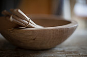 Close up bundled wooden spoons in bowl