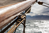 Close up wooden sailboat mast and rigging