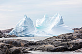 Melting iceberg formation among rocks Greenland