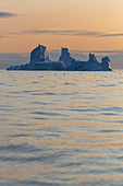 Majestic iceberg formations on sunset