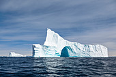 Majestic iceberg arch on blue Atlantic Ocean Greenland