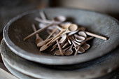 Close up tiny wooden spoons in dish