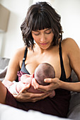 Mother breastfeeding newborn baby son