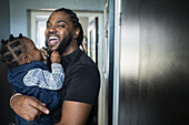 Portrait happy father holding toddler son