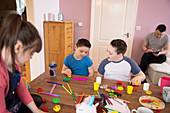 Boy with Down Syndrome and siblings playing with toys