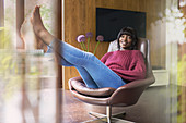 Portrait carefree woman relaxing in home office