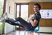 Portrait happy man with dog in home office