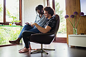 Young couple using digital tablet in home office