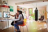 Creative entrepreneurs working at computer in home office