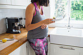 Pregnant woman eating in kitchen