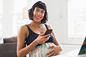 Portrait happy pregnant woman using smart phone