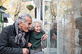 Senior couple window shopping at storefront