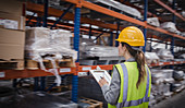 Female factory worker checking inventory in warehouse