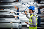 Male worker checking inventory in warehouse