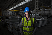 Portrait confident, serious worker in dark steel factory