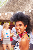 Portrait confident, smiling young woman at summer party
