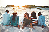 Young friends hanging out on beach