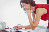 Brunette woman working at laptop