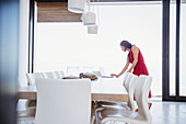 Woman working at laptop in dining room