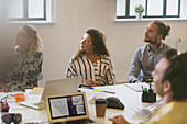 Attentive designers listening in conference room meeting