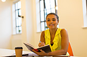 Attentive businesswoman taking notes in meeting